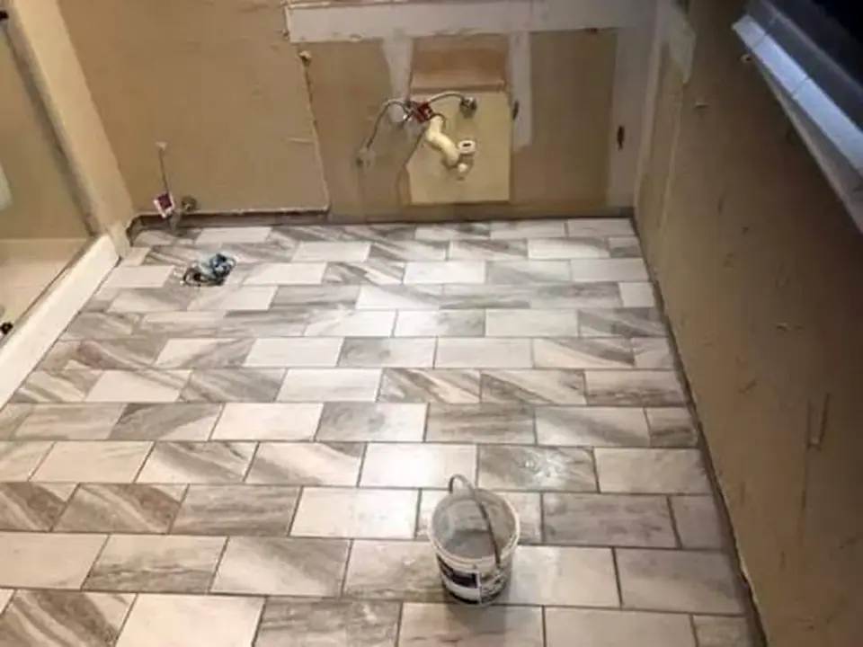 Bathroom floor tile installation in progress