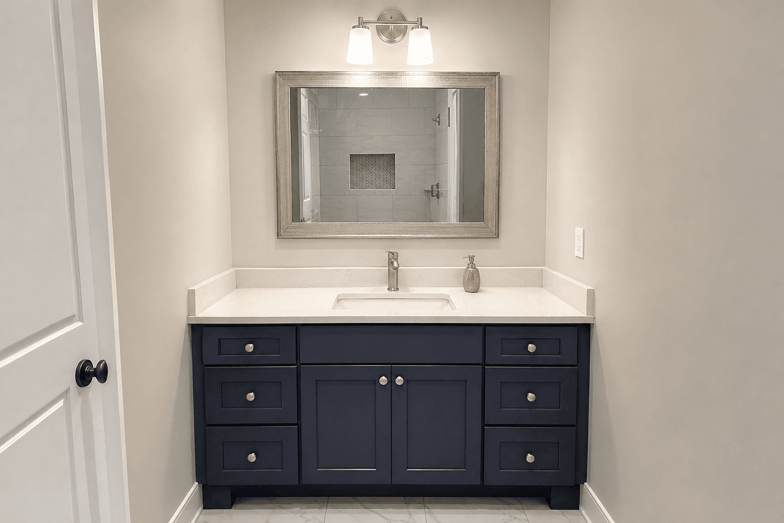 Navy double vanity with a white counter and framed mirror