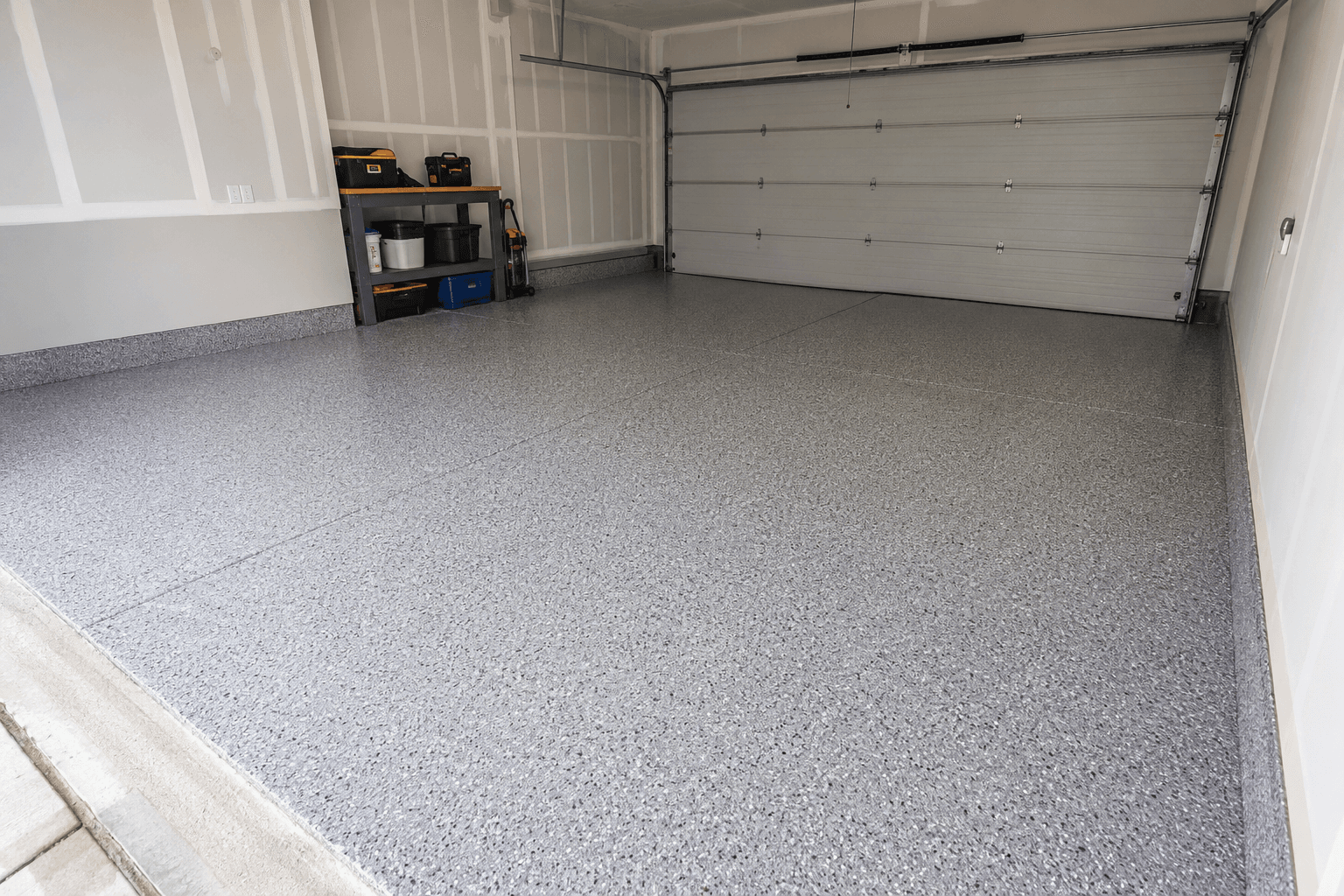 Garage with a finished grey flake epoxy floor