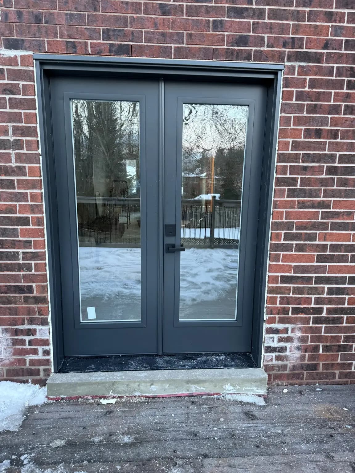 Black double patio doors with full-height glass panels