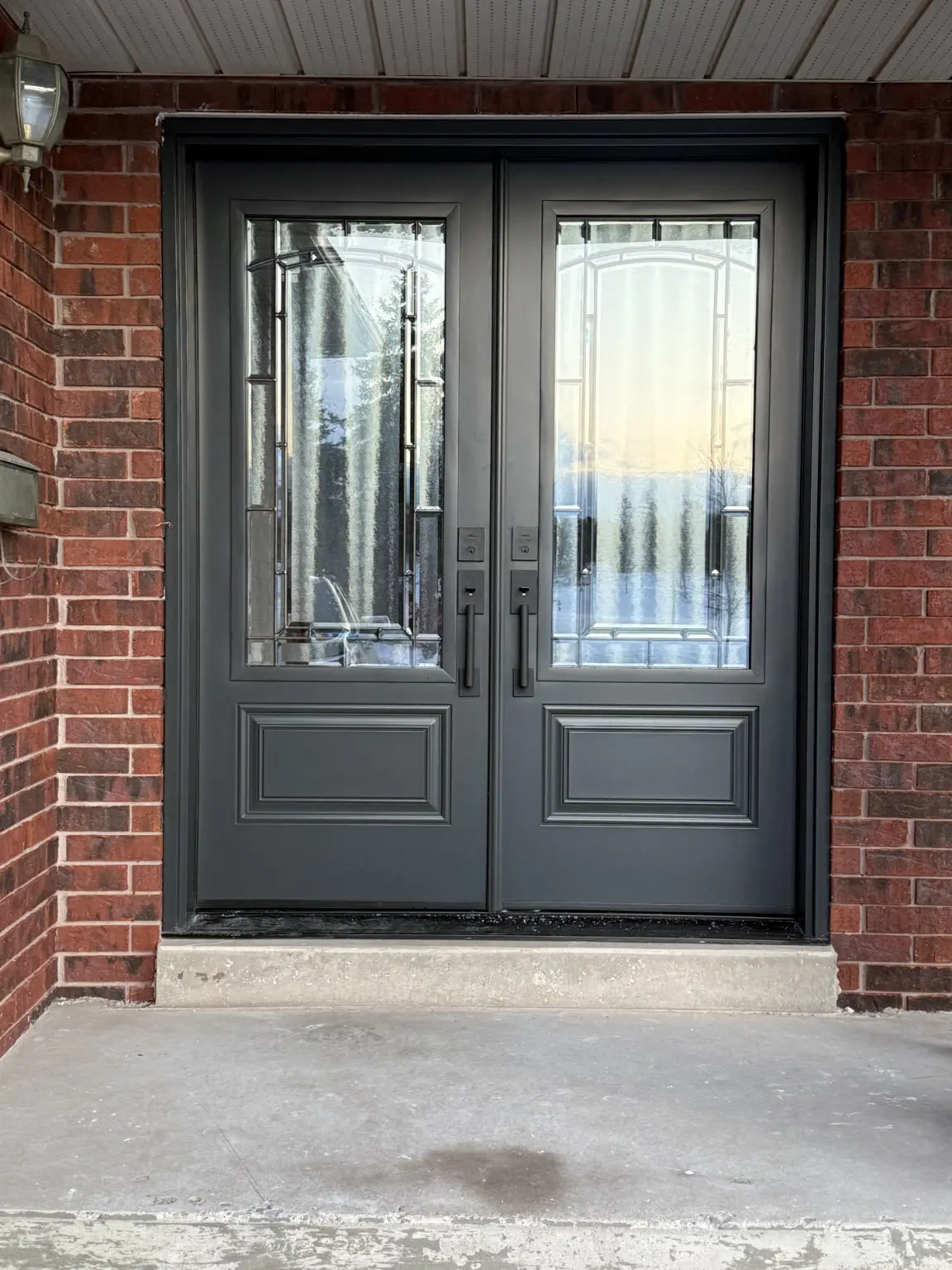 Charcoal double entry doors with decorative glass panels