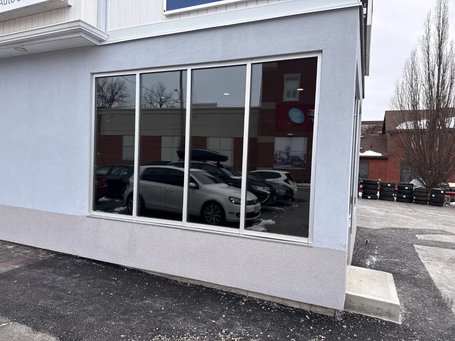 Finished wall of large commercial windows in a white exterior