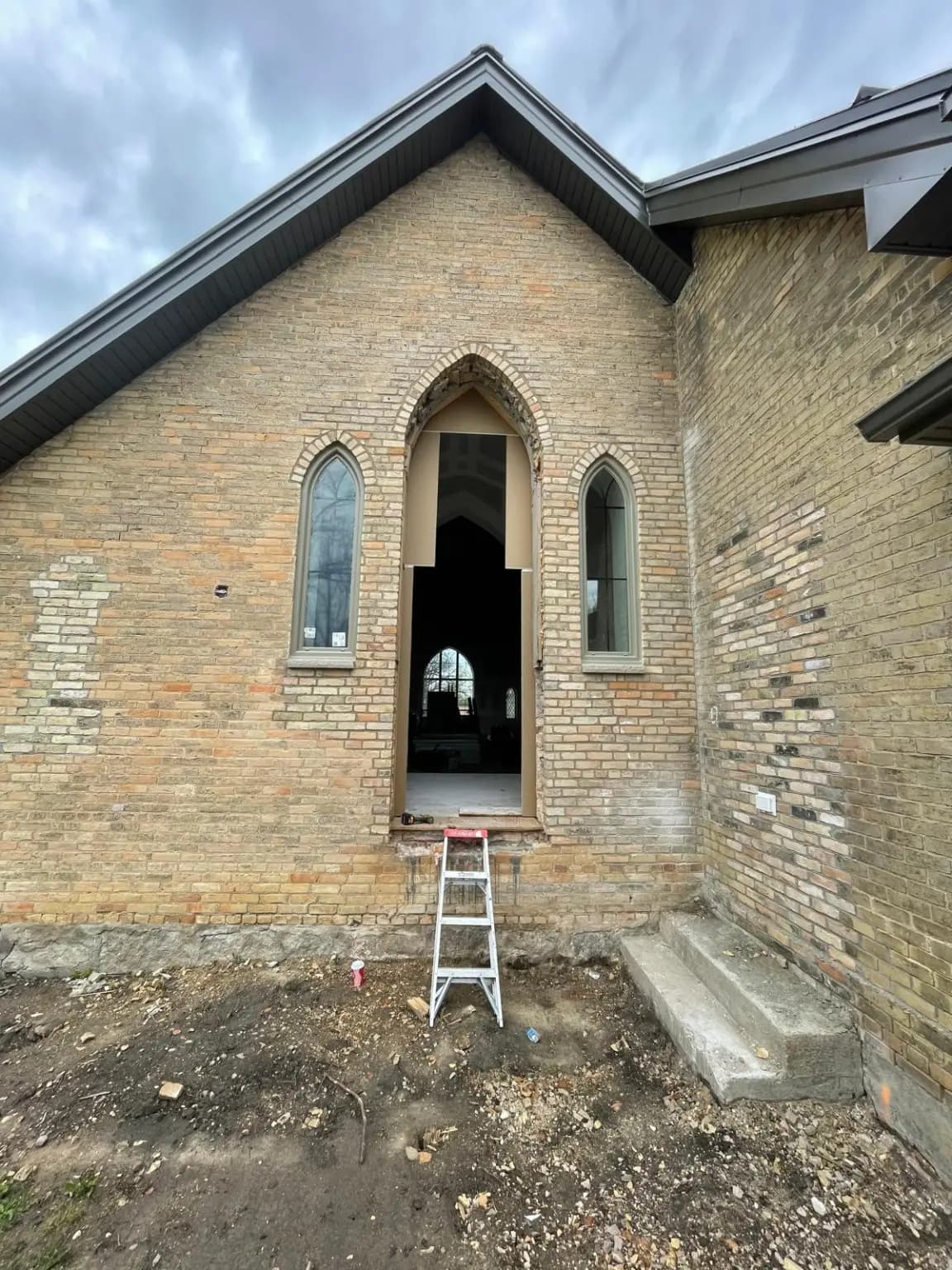 Large custom arched opening prepared for a new window installation